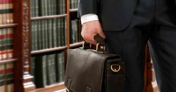 lawyer-in-library-holding-briefcase-closeup_573x300